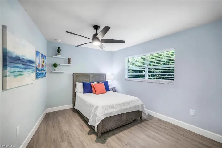 Bedroom with light hardwood / wood-style floors and ceiling fan