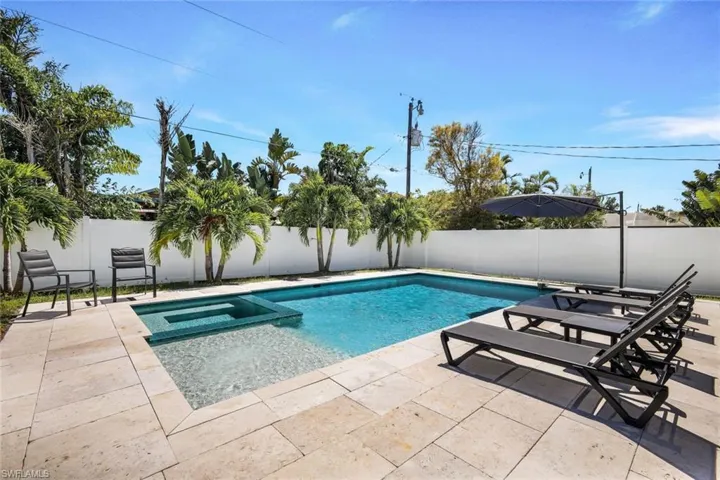 View of pool featuring an in ground hot tub and a patio