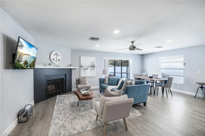 Living room featuring ceiling fan and light hardwood / wood-style flooring