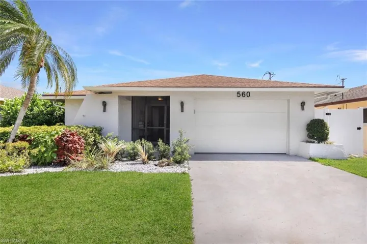Ranch-style home with a garage and a front yard