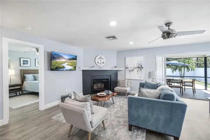 Living room with ceiling fan and light wood-type flooring