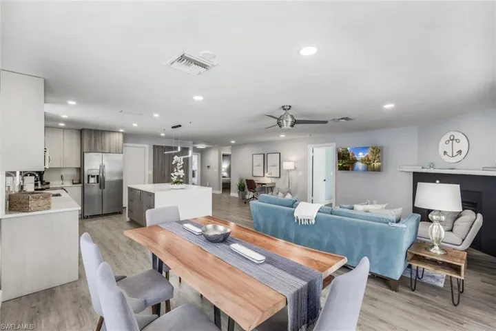 Dining space with ceiling fan, light hardwood / wood-style floors, and sink