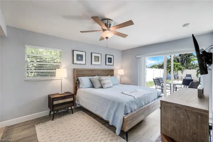 Bedroom with dark hardwood / wood-style flooring and ceiling fan