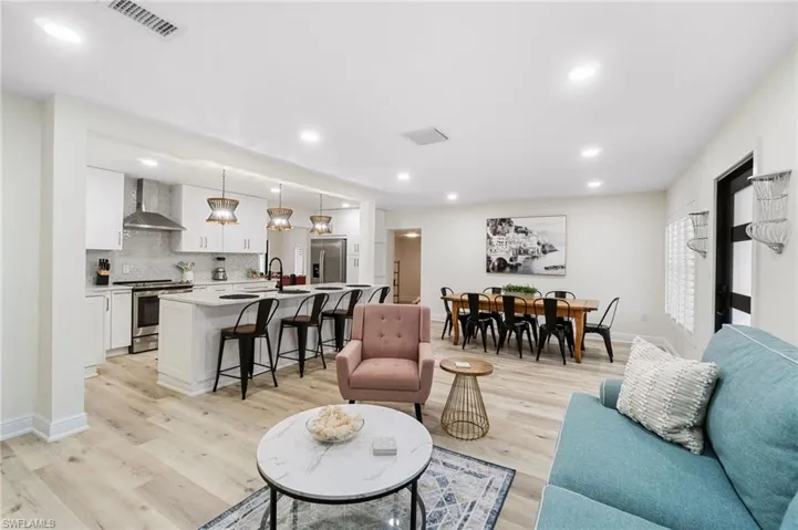First living area featuring light wood-type flooring and recessed lighting, open floor plan