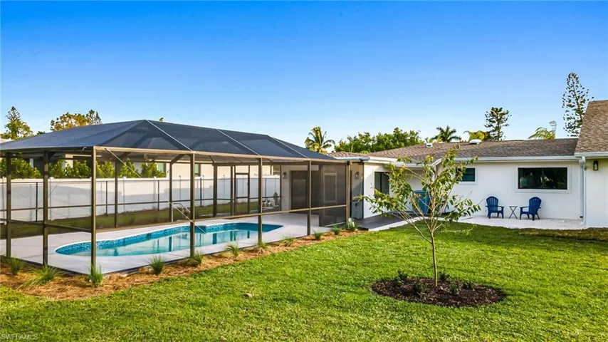 Back of property featuring a patio, a sunroom, a lanai, and stucco siding