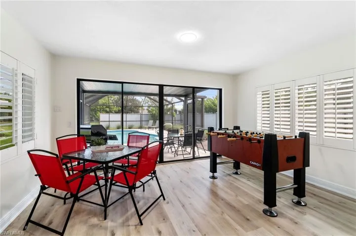 Game room featuring healthy amount of natural light and light wood-type flooring