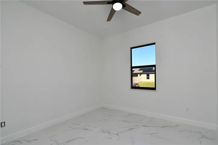 Unfurnished room featuring ceiling fan