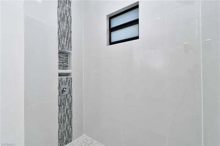 Bathroom featuring tiled shower