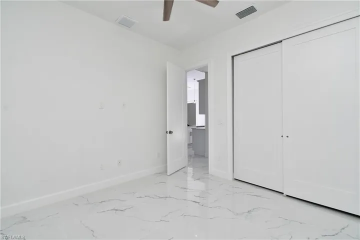 Unfurnished bedroom featuring ceiling fan and a closet
