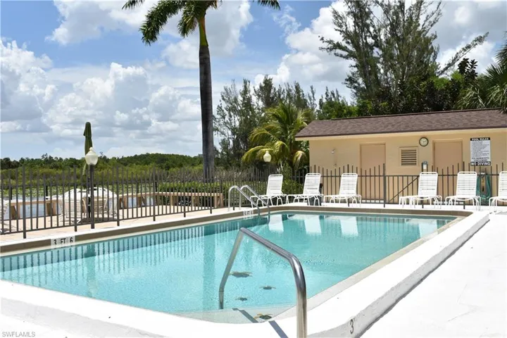 Community pool with a patio
