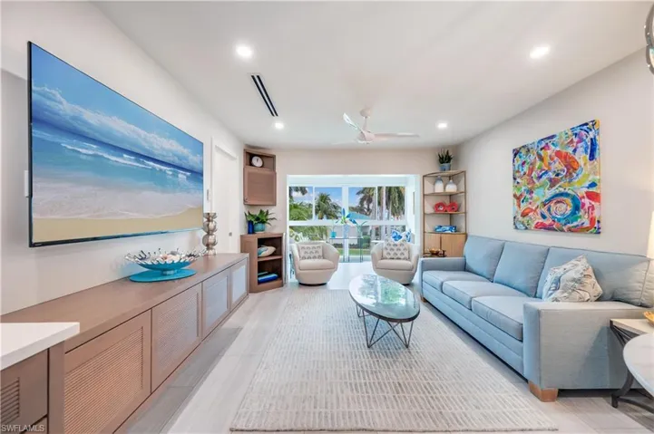 Living room with ceiling fan and recessed lighting