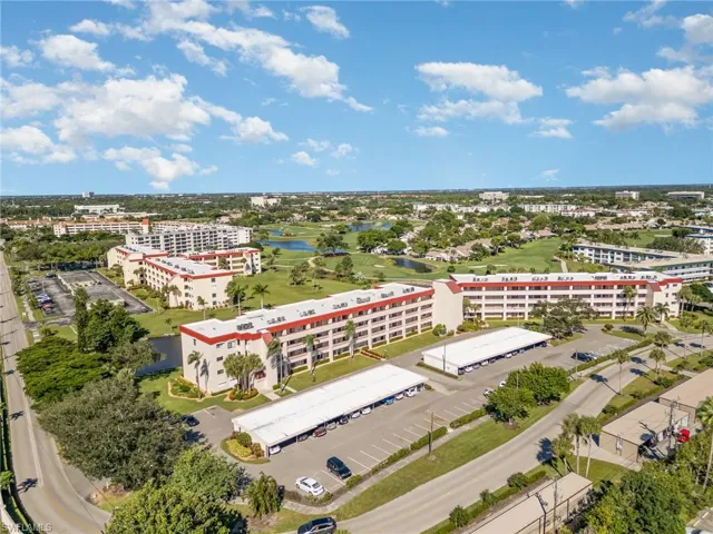 Aerial view of building #23, carport spaces, and the golf course