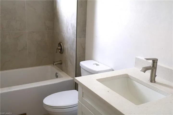 Full bathroom with vanity, toilet, and shower / washtub combination