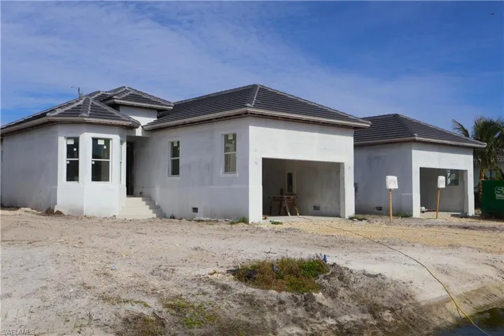 Rear view of property featuring a garage