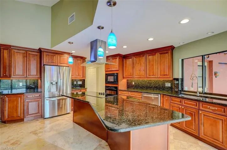 Kitchen with island exhaust hood, a kitchen breakfast bar, a center island, and black appliances