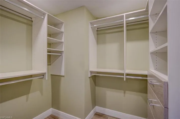 View of walk in closet w/California Closet design