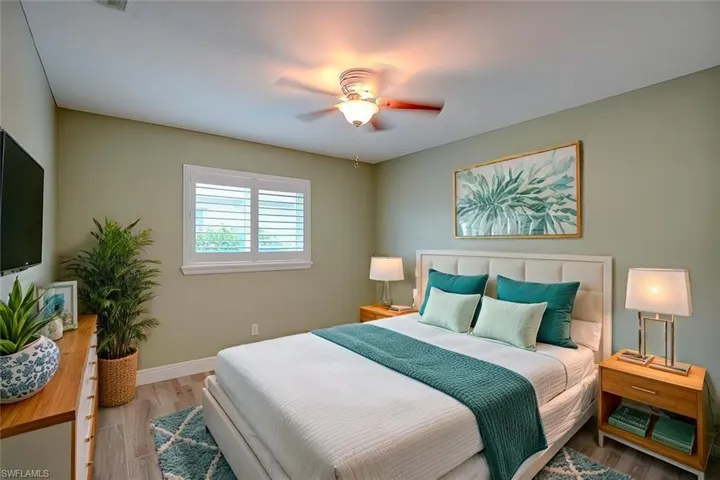 Bedroom featuring light hardwood / wood-style floors and ceiling fan