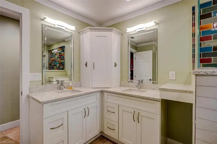 Bathroom with vanity and ornamental molding