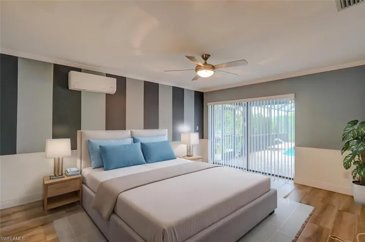 Bedroom featuring access to outside, a wall unit AC, ceiling fan, crown molding, and light hardwood / wood-style floors