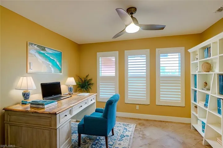 Office space with ceiling fan and plenty of natural light