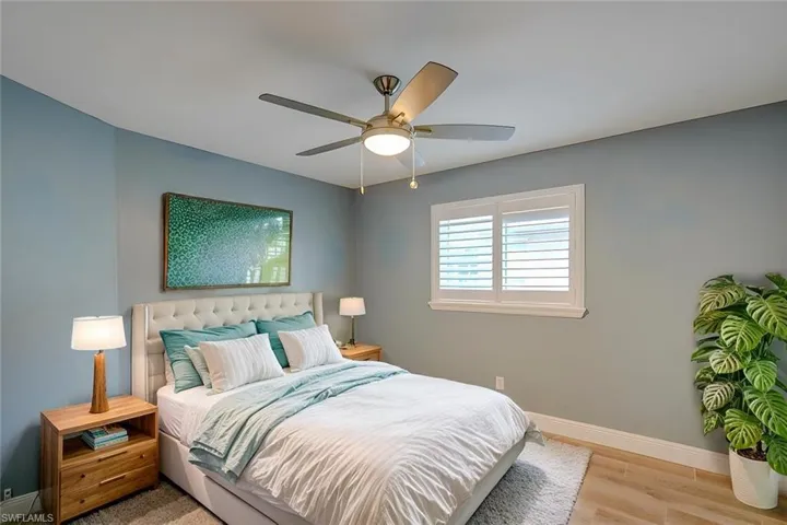 Bedroom featuring ceiling fan and light hardwood / wood-style flooring