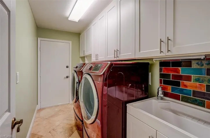 Laundry area featuring cabinets and independent washer and dryer