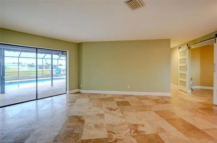 Unfurnished room featuring a barn door