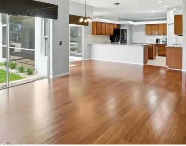 Spare room with light wood-style floors and baseboards