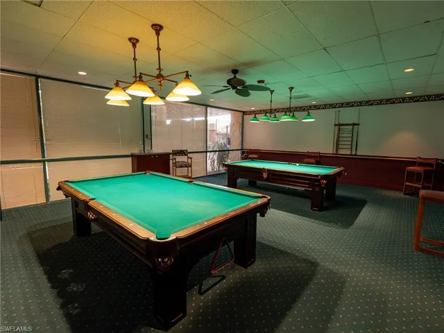 Playroom featuring ceiling fan, pool table, and carpet