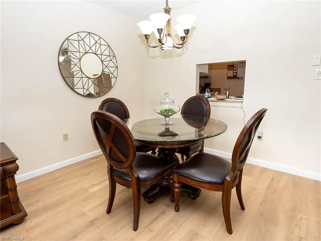 Dining area with light hardwood / wood-style flooring and a chandelier