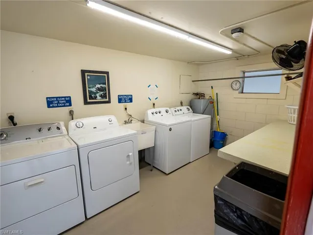 Washroom featuring washing machine and clothes dryer and sink