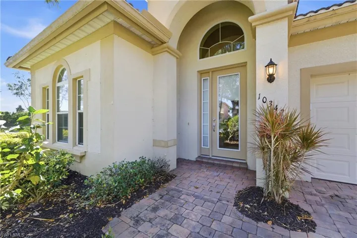 Property entrance featuring stucco siding