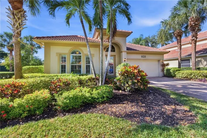 Mediterranean / spanish-style home featuring stucco siding, a garage, driveway, and a tiled roof