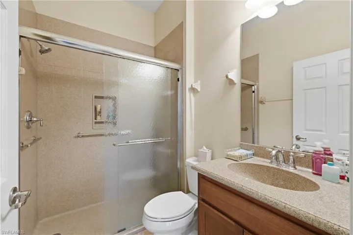Bathroom featuring vanity and a stall shower