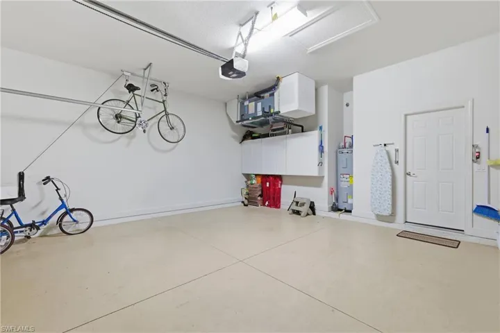 Garage with electric water heater and a garage door opener
