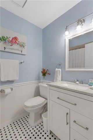 Bathroom with vanity, toilet, and tile patterned floors