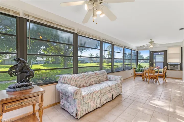 Sunroom featuring cooling unit and ceiling fan