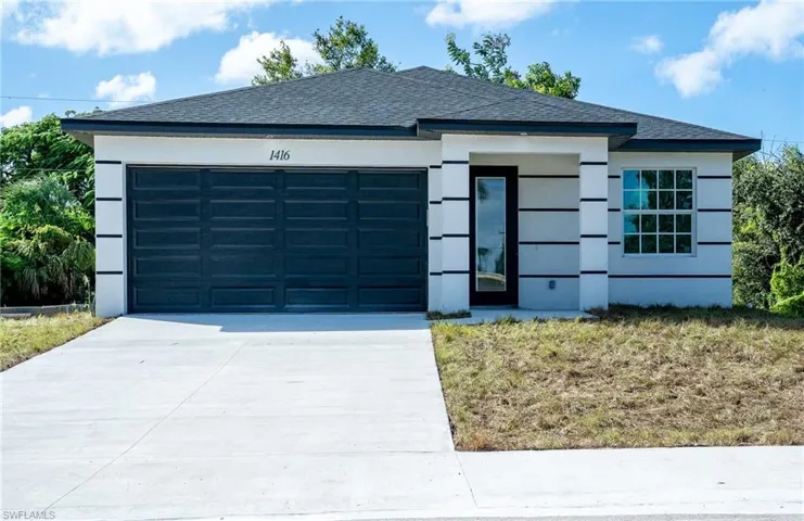 View of front facade featuring driveway, roof with shingles, an attached garage, and stucco siding