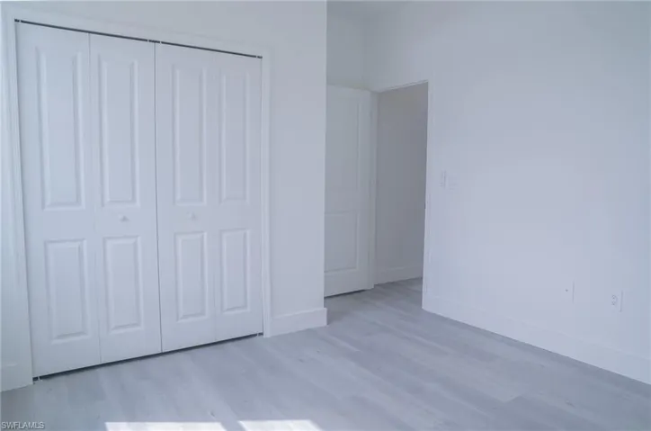 Unfurnished bedroom with light wood-style flooring and a closet