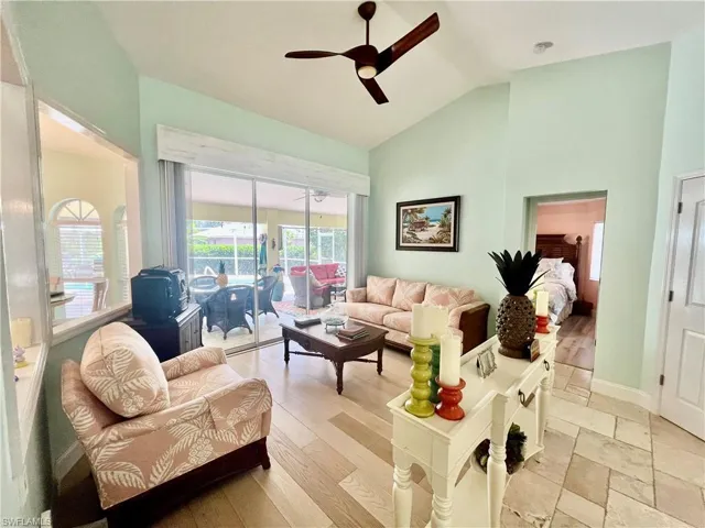 Living room featuring plenty of natural light, high cathedral ceilings and luxury vinyl plank floors.