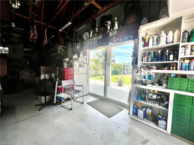 Interior of detached garage with sliding doors to the covered porch area.
