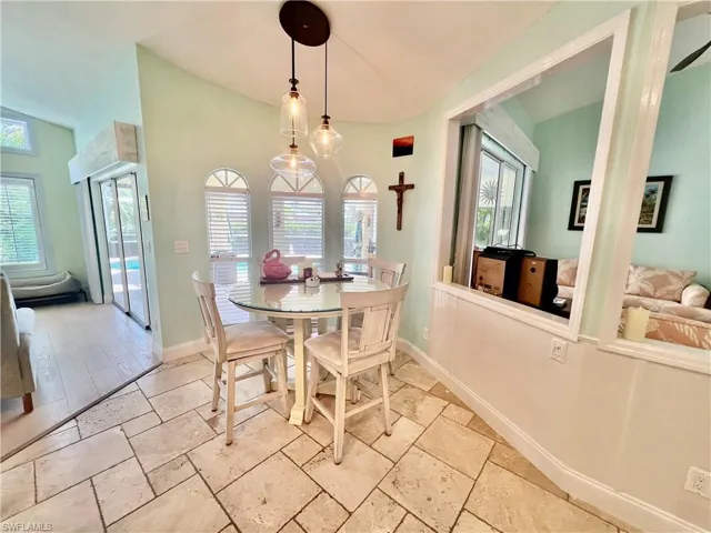 Eat in kitchen/nook area overlooking the pool with TRAVERTINE stone tile floors.
