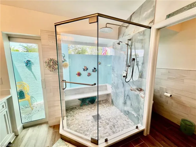 Frameless glass shower overlooking the atrium.