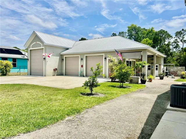 Detached Garage surrounded by nicely landscaped yard and covered porch from the garage area.