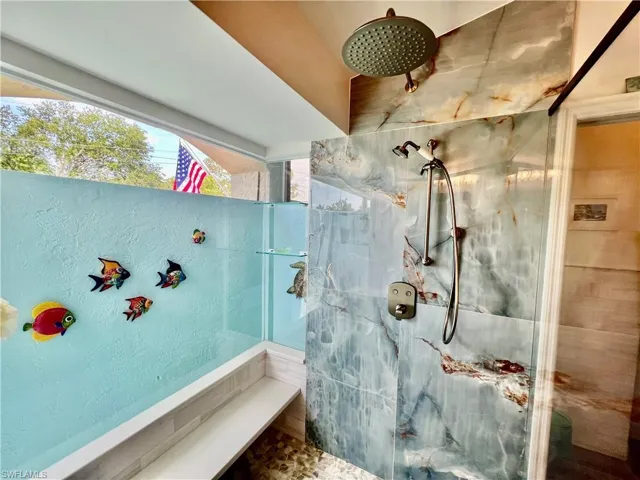 Frameless glass shower overlooking the atrium.