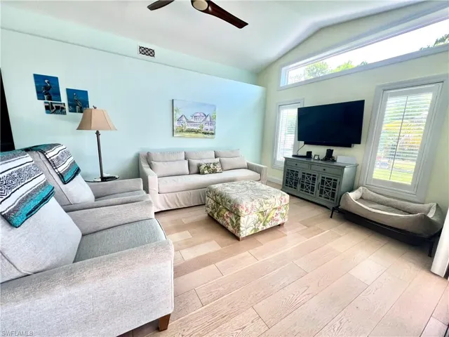 Family room with cathedral ceilings, luxury vinyl plank floors and access to pool area.