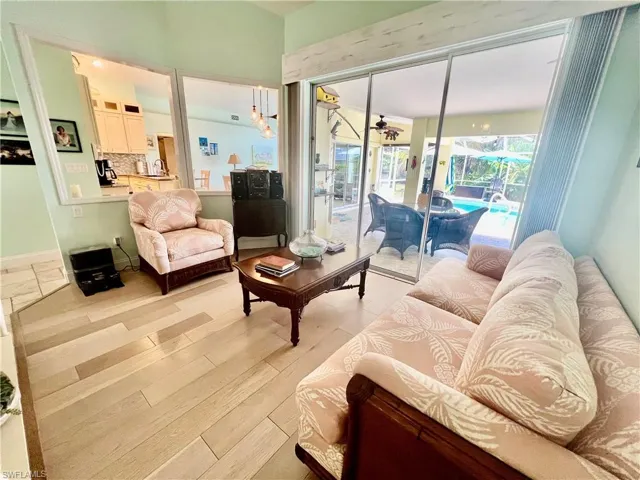 Living room featuring plenty of natural light, high cathedral ceilings and luxury vinyl plank floors.
