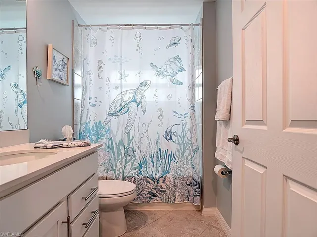 Bathroom with vanity and light tile patterned flooring