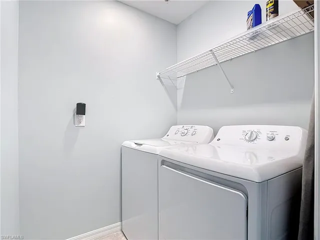 Laundry room featuring baseboards and separate washer and dryer