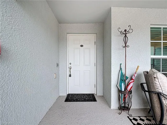 View of exterior entry featuring stucco siding